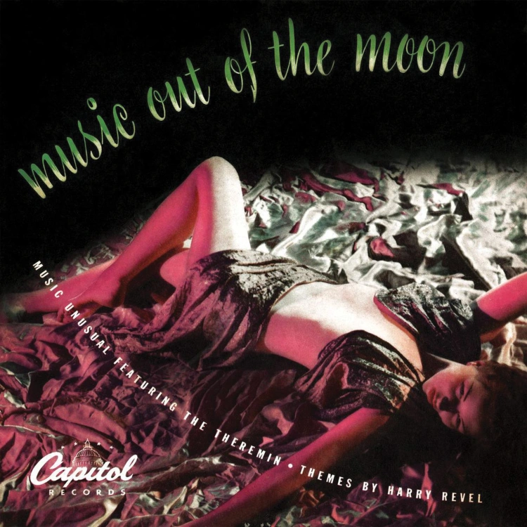Album cover for record mentioned in title. Scene of woman laying on what looks to be shiny silver satin with green cursive text overlaid in with the album title.